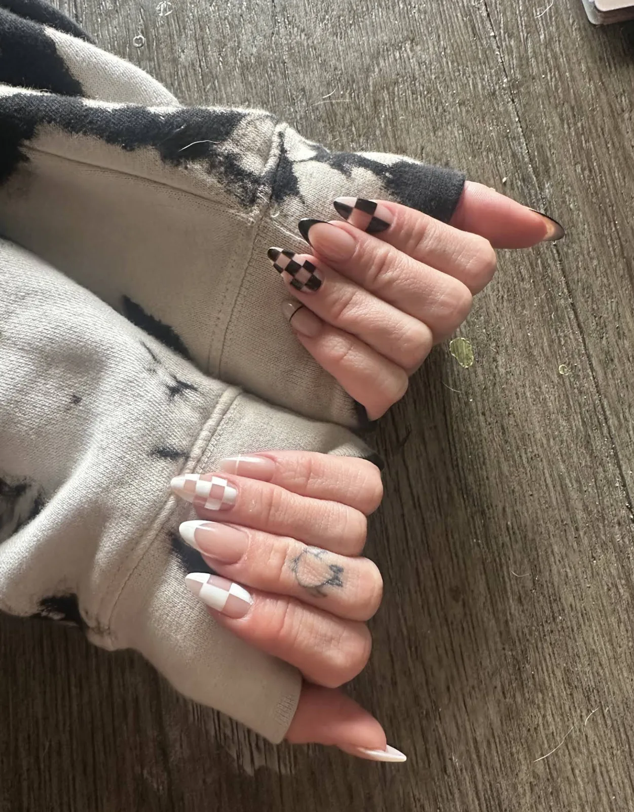 Client's almond nails with black and white checkerboard French tips
