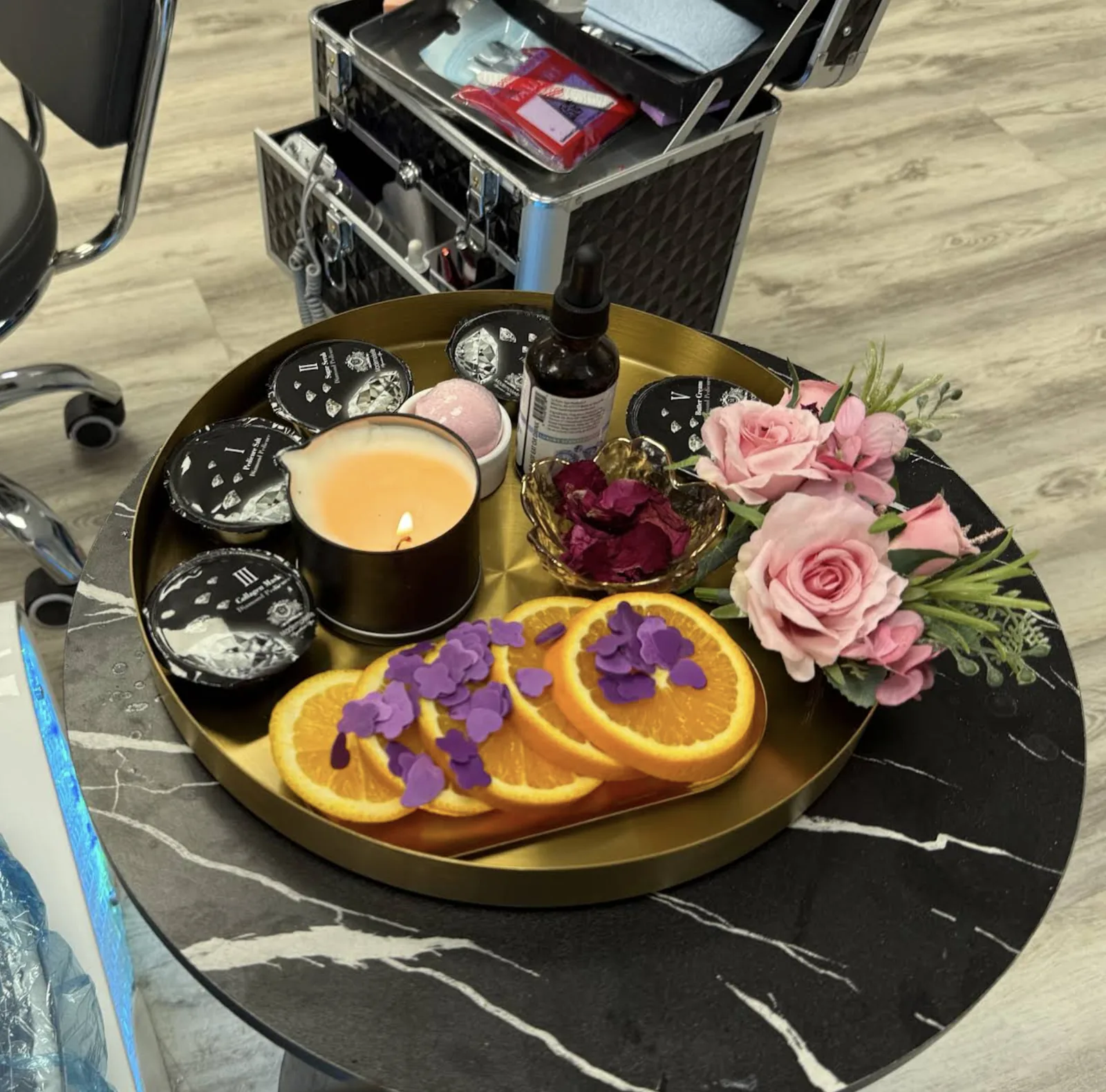 Diamond Pedicure products with candle, rose petals and orange slices